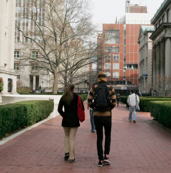 Rear view of college students walking on campus