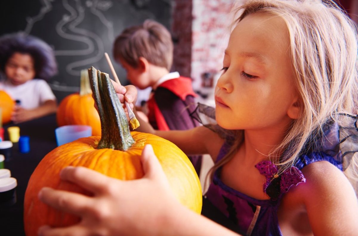 Kids painting pumpkins