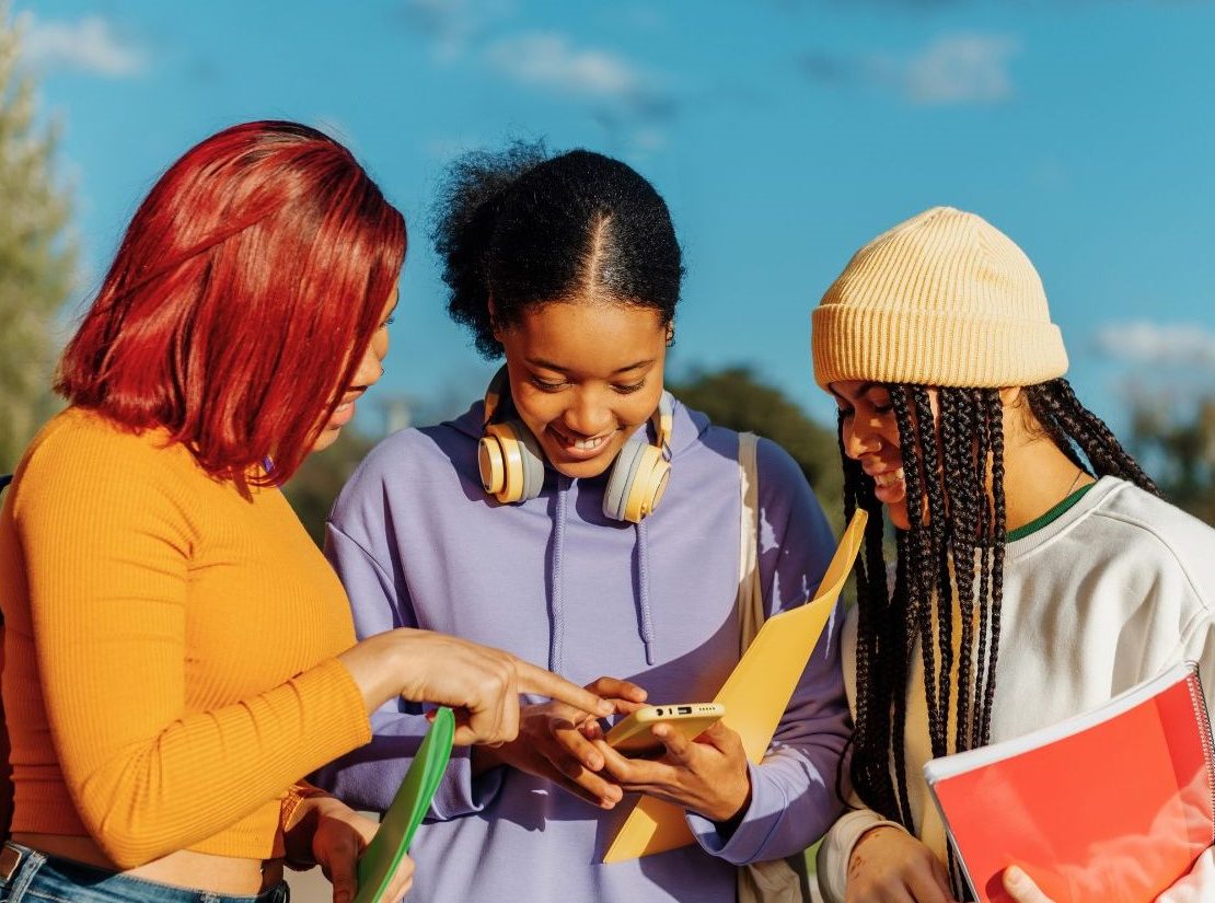 Sep2025_GoodStuff_CvrImage_StudentsCheckingCellPhone.